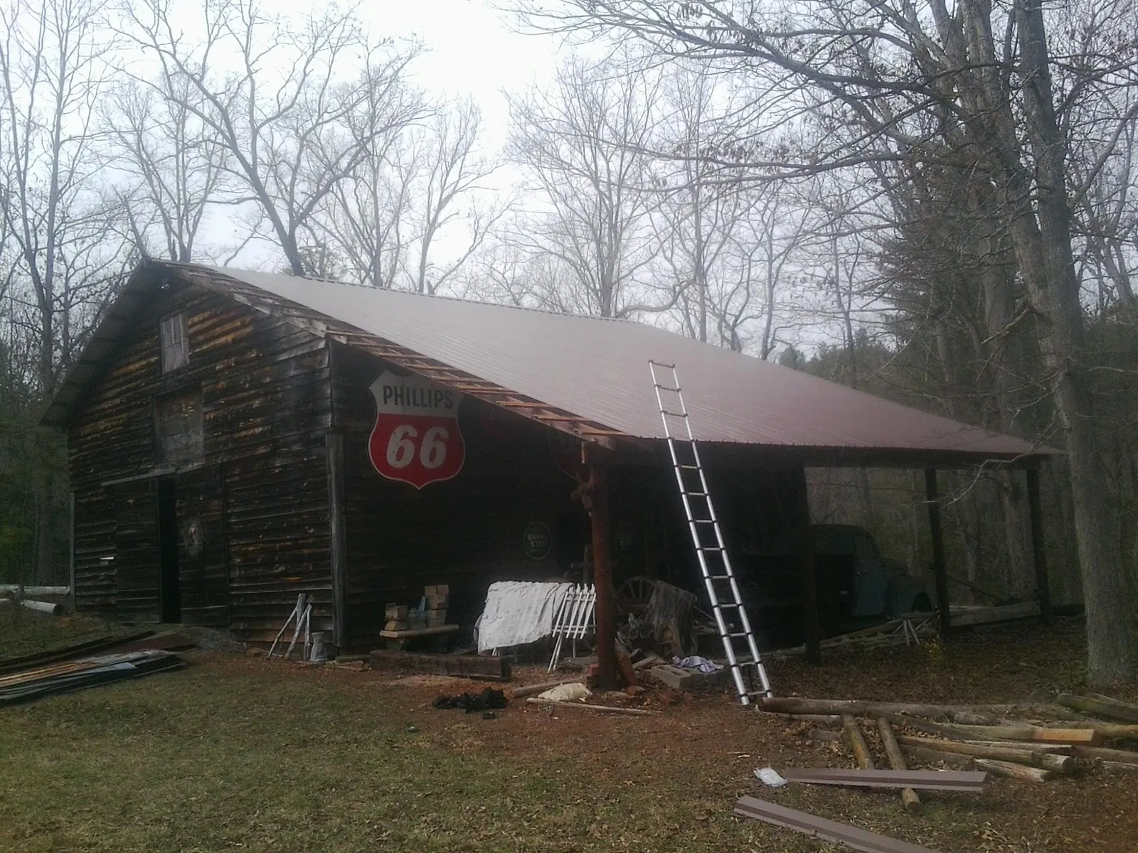 New metal roof on an open sided timber barn with a vintage sign in Glide